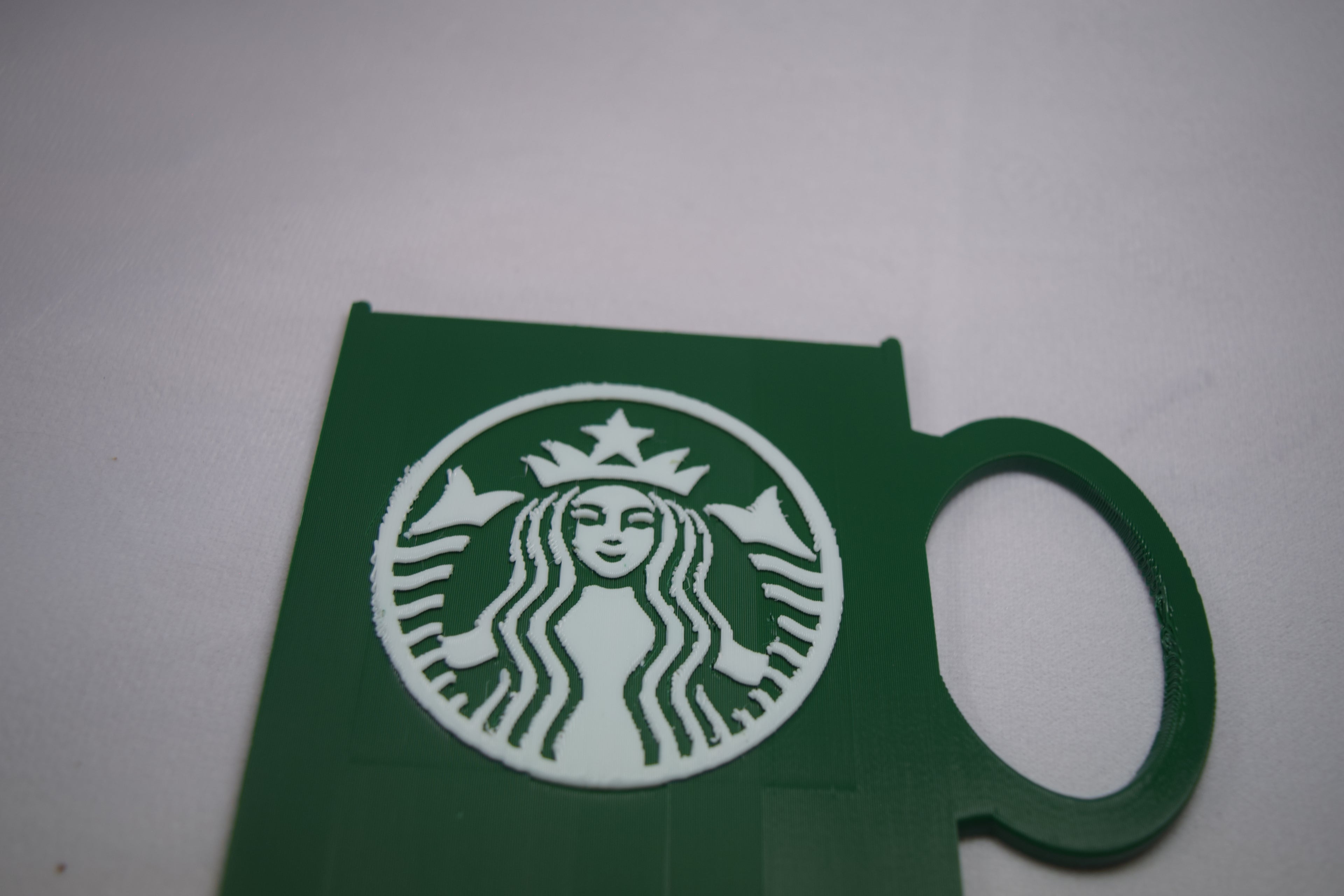 Starbucks mug gift card holder, green 3D-printed sleeve with white Starbucks logo by Bryans3dPrints