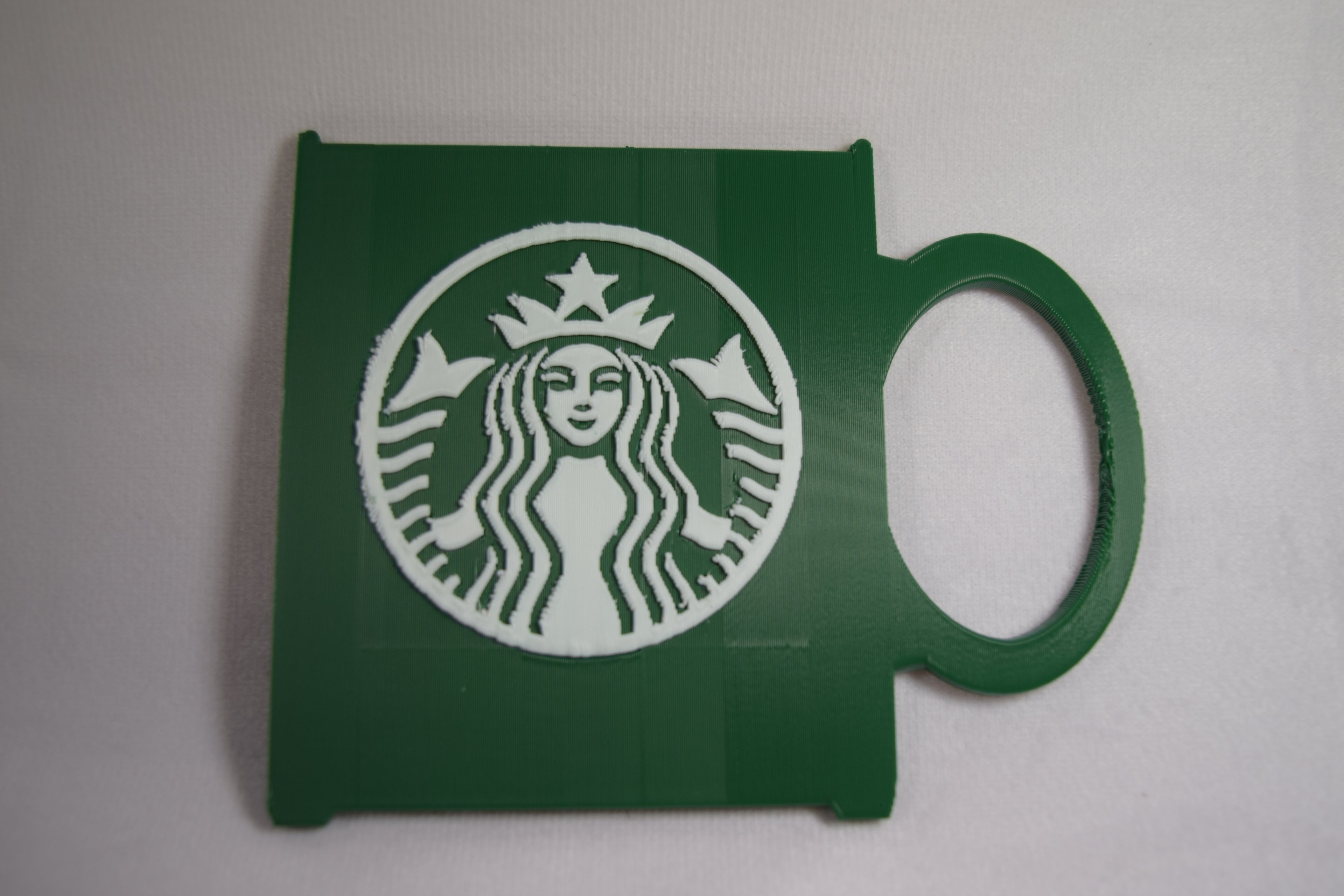 Starbucks mug gift card holder, green 3D-printed with white Starbucks logo and built-in handle.